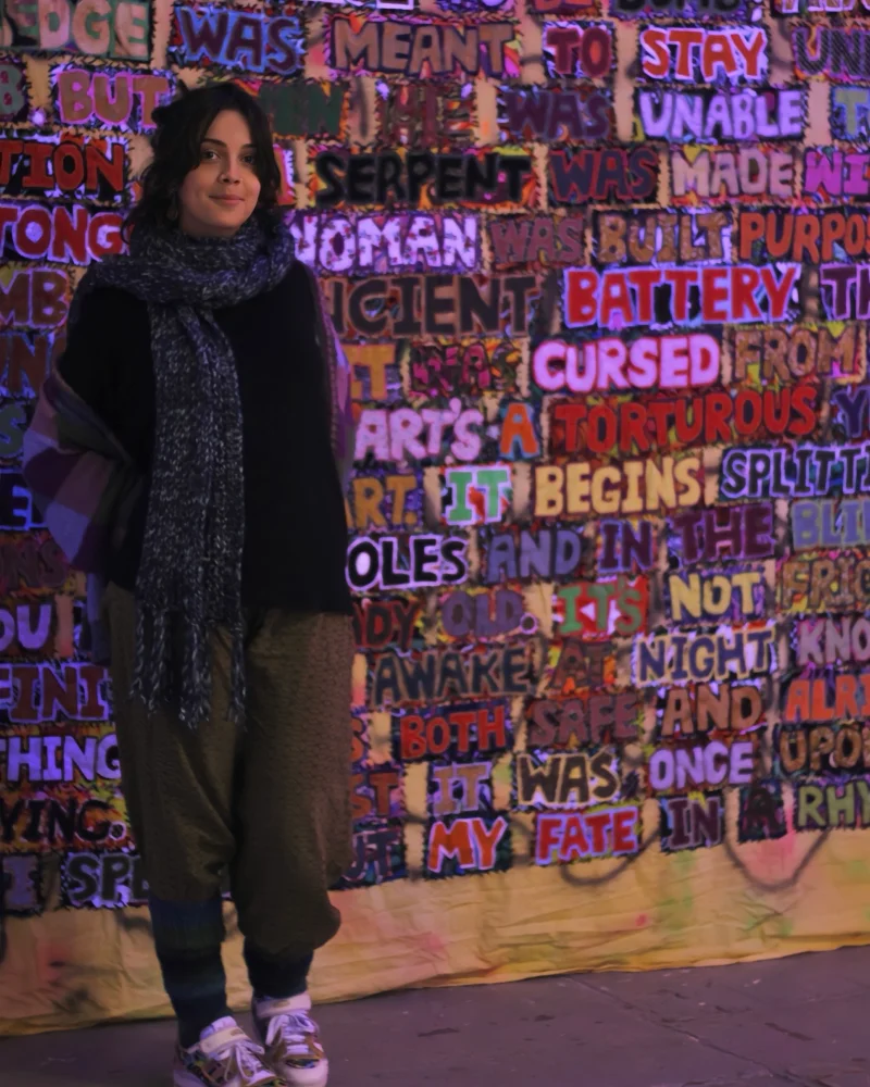 Kim stood in front of her large scale tapestry titled 'Prophecy' which contains the words of a long nihilistic poem about fate and chance