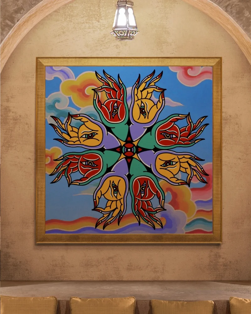 A mock-up of Kim's illustration 'The Seraphim Mudra' on a cream arched wall with a gold frame. Below it are gold cushions.